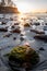 Sun set glows over rocks at low tide