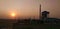 Sun set over a steel plant situated beside National High Way of India.