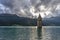 The sun sets behind the famous submerged bell tower in Lake Resia, Curon Venosta, South Tyrol, Italy