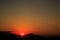 The sun sets behind the mountains. beautiful panorama and view of the setting sun
