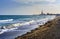 The sun sets over the horizon of Badalona, Spain, reflecting off the waves of its idyllic bay. Surfers take advantage of the wind