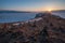 The sun sets over the mountains on winter Lake Baikal.