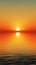 Sun sets over a sea, its reflection stretching across the water. The gradient of orange to yellow suggests a tranquil, reflective
