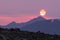 Sun Sets Through Smoky Skies Over Rocky Mountains