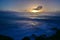 Sun setting above the horizon as viewed from Southern Breakwater Viewing Platform in Greymouth, New Zealand