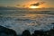 Sun setting above the horizon as viewed from Southern Breakwater Viewing Platform in Greymouth, New Zealand