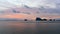 Sun setting behind the hilly islands and cliffs at Krabi, Thailand