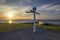 The sun setting behind the iconic signpost at John O`Groats in the Scottish Highlands