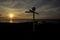 The sun setting behind the iconic signpost at John O`Groats in the Scottish Highlands