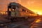 sun setting behind line of decaying train cars