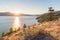 Sun setting behind mountains on Okanagan Lake on summer evening on Naramata Bench