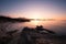 Sun setting over beach and calvi citadel in Corsica