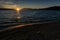 Sun setting over Big Bear Lake Lighting Up The Rock On The Beach