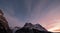 The sun setting over the Eiger and other mountains surrounding the Alpine village of Grindelwald, Switzerland.