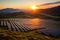 The sun is setting over a large solar farm created with generative AI technology