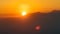 Sun setting over the mountains. Sunset or sunrise at mountains. Orange scene