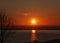 Sun setting over Pegwell Bay, Kent and reflecting in the water. There are rays from the sun