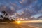 Sun setting over waves on the beach and a vast sky on Sunset Beach in Hawaii