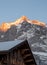 The sun setting over the Wetterhorn mountain behind the Alpine village of Grindelwald, Switzerland.