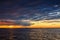 Sun setting at the sea with sailing cargo ship, scenic view