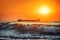 Sun setting at the sea with sailing cargo ship, scenic view