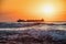 Sun setting at the sea with sailing cargo ship, sunrise view