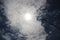 The sun shines through Altocumulus clouds with a clear blue sky background in the midday