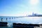 Sun shines bright over Chicago skyline and a frozen Lake Michigan in winter