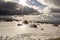 The sun shines through the clouds in a snowy mountain range. winter landscape, Serra da Estrela