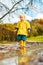 Sun always shines after the rain. Small bond infant boy wearing yellow rubber boots and yellow waterproof raincoat