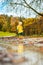 Sun always shines after the rain. Small bond infant boy wearing yellow rubber boots and yellow waterproof raincoat