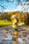 Sun always shines after the rain. Small bond infant boy wearing yellow rubber boots and yellow waterproof raincoat