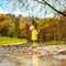 Sun always shines after the rain. Small bond infant boy wearing yellow rubber boots and yellow waterproof raincoat