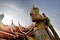 Sun shines through the roof of a temple and a Thai giant guarding a temple in Bangkok,Thailand.