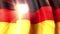 The sun shines through the waving flag of germany. Animated background. Germany waving flag on blue sky for banner design. German
