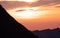 sun shining behind mountain range, dramatic sunset in the swiss alps brienzer rothorn