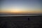 Sun sinks into the sea on the beach of Katwijk with colorful sky