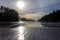 Sun sinks to horizon over rippled sand at Schooner Cove