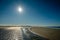 Sun is slowly setting along the Schiermonnikoog summer coastline Netherlands