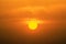 Sun during sunset with reddish glow in clouds