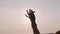 Sun Throught Hand.Woman Looks At The Sun Through Hand.Grasping Sun With Palm.Sun Through Finger.Silhouetted Woman Hand