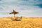 Sun umbrella and chairs in desert