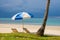 Sun umbrella and chairs on a tropical beach