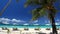 Sun umbrellas and beach chairs on coastline with white sand