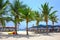 Sun umbrellas and beach chairs on tropical coastline, Thailand