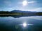 Sun in the water of the taiga lake