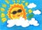 The sun wearing sunglasses in midsummer day with blank space in the clouds