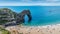 Sunbathers enjoying the warm sunshine at Durdle Door beach of Jurassic Coast, West Lulworth, United Kingdom