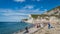 Sunbathers enjoying the warm sunshine at Durdle Door beach of Jurassic Coast, West Lulworth, United Kingdom