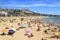 Sunbathers at Miracle Beach in Tarragona, Spain